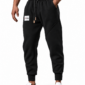 C63s black fleece joggers with white logo patch on right upper leg